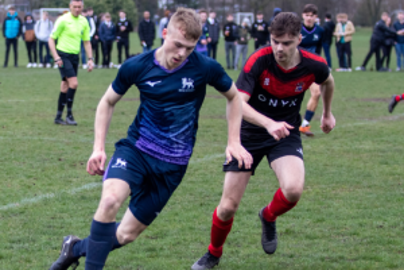 Two players fighting for the ball playing football