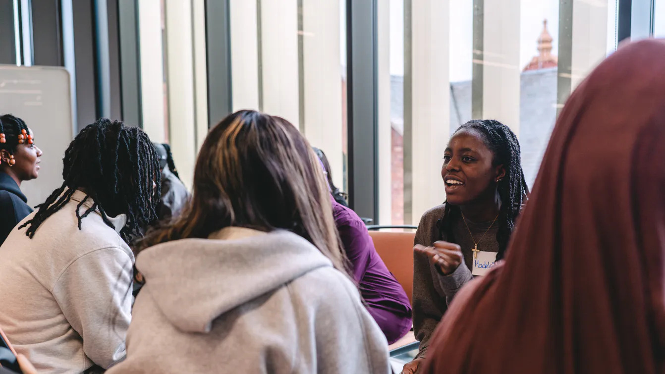 Student sitting talkking at a rise event