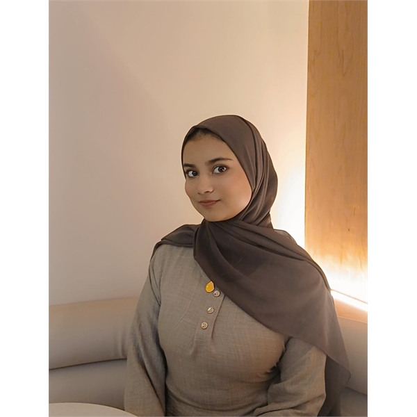 Nabihah is sitting down wearing a brown/beige coloured hijab