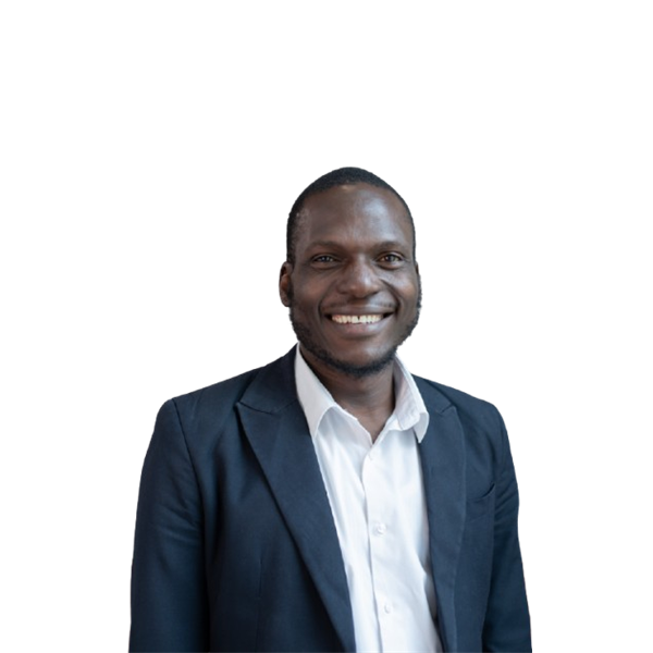 Shakiru has black hair and is wearing a blue blazer with a white shirt