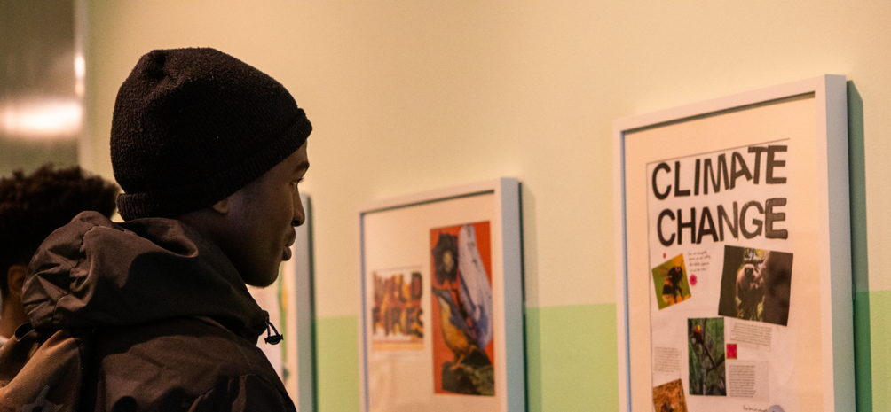 students admiring an art piece on climate change