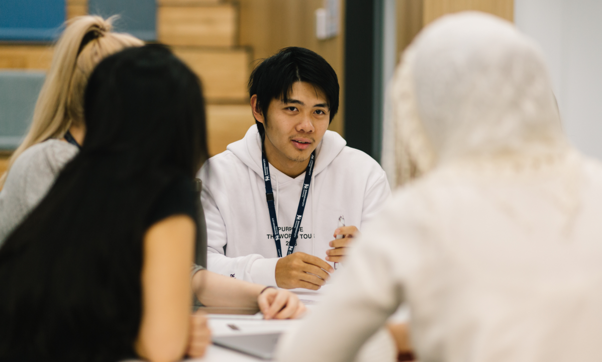 students talking in a meeting
