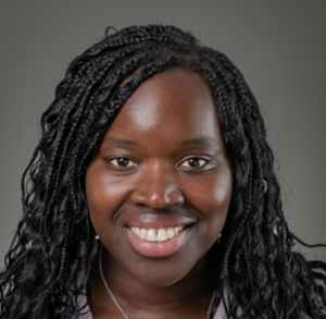 Ana has black hair and is smiling at the camera